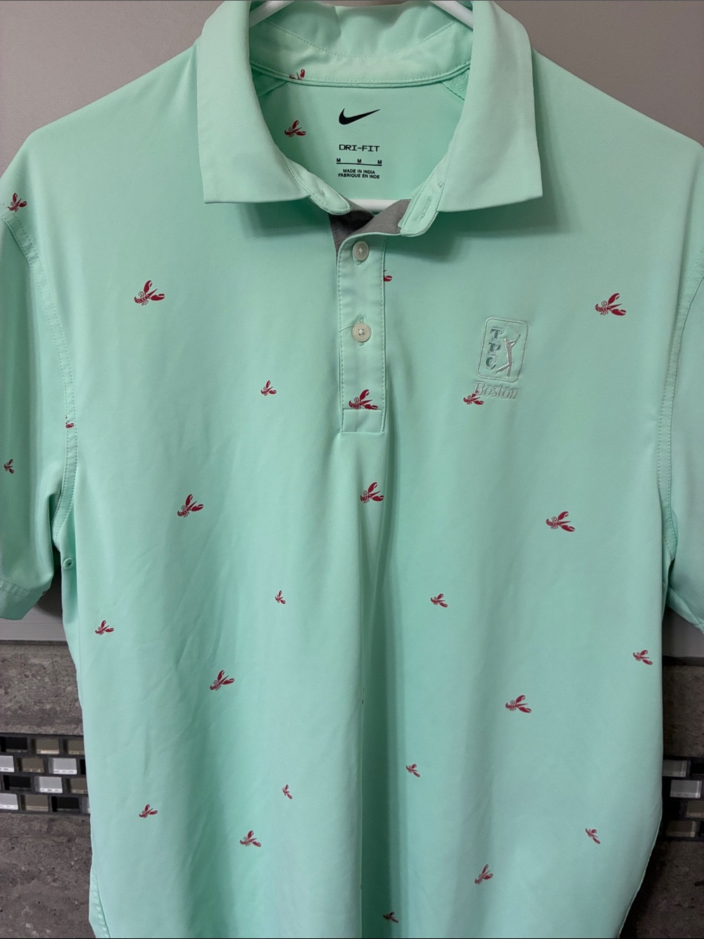 Nike Mint Green Polo with Small Red Embroidered Motifs